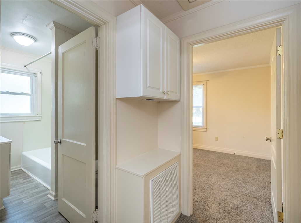 201 Blue Ridge Circle Belton, SC 29627 - Photo 12 of 30 A functional hallway layout connects a neat bathroom to a carpeted bedroom nearby.