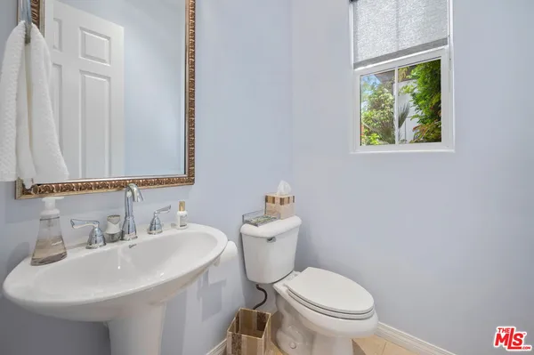 a spacious bedroom with a bed and a chandelier
