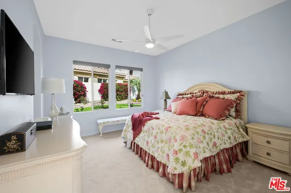 a spacious bathroom with a double vanity sink a mirror and a shower