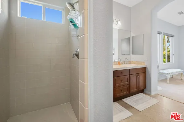 a bathroom with a sink a vanity and a mirror