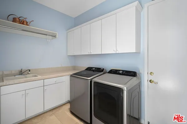 a bathroom with a granite countertop sink a toilet a mirror and shower