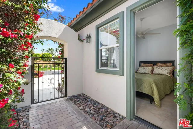 a view of a patio with chairs and plants