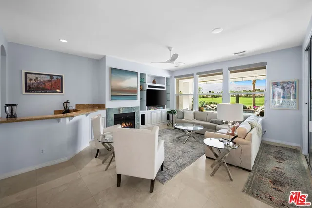 a living room with fireplace furniture and a flat screen tv