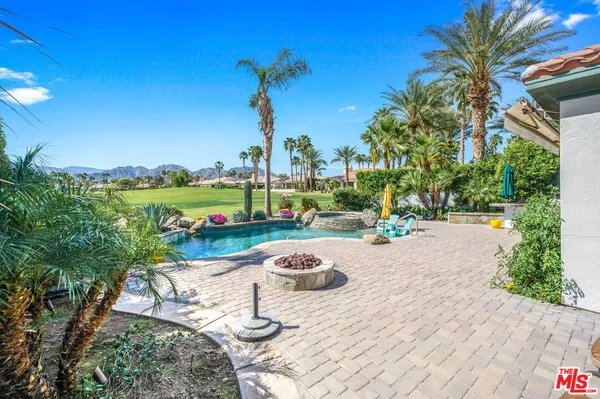 a front view of a house with swimming pool having outdoor seating