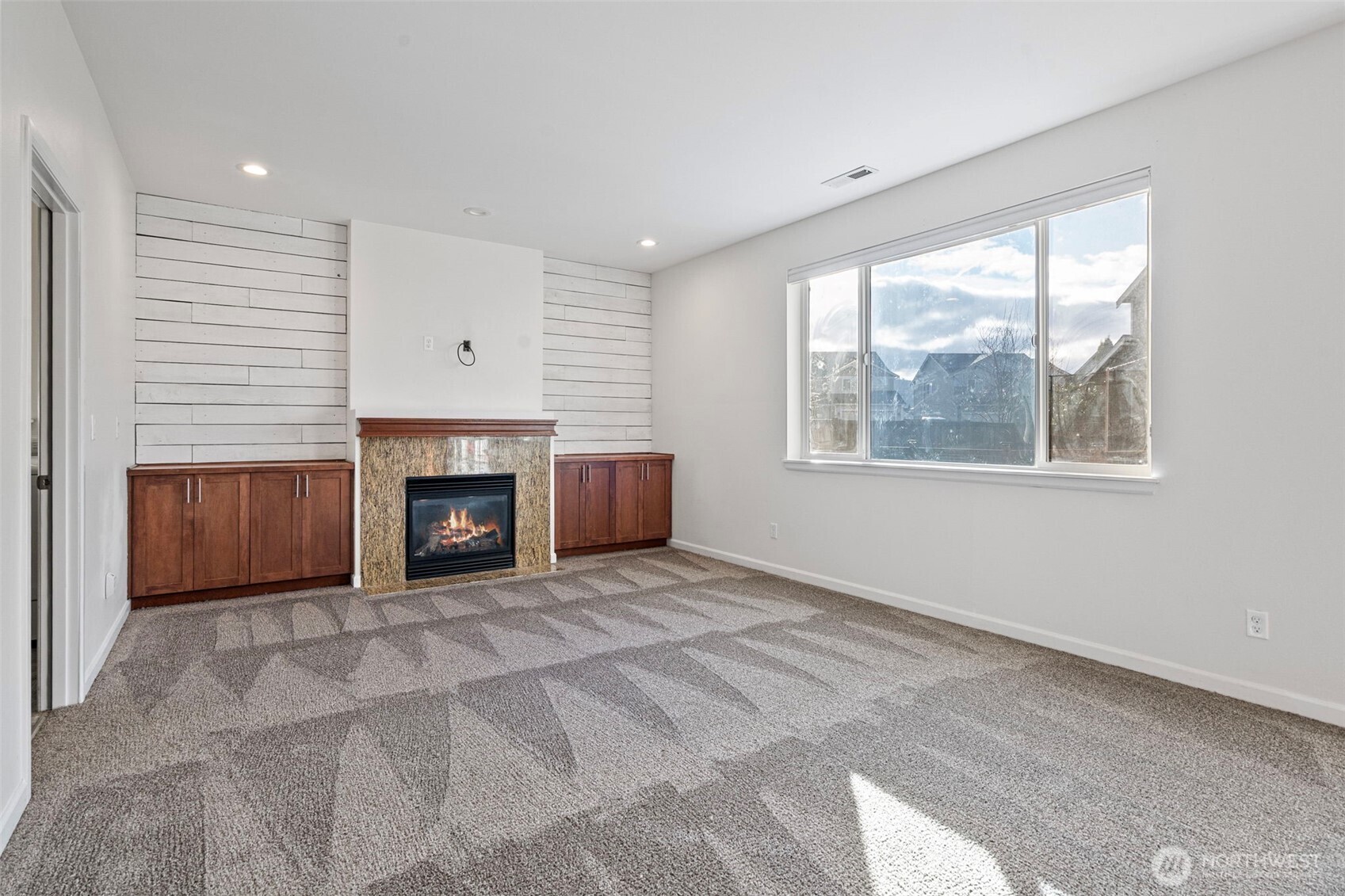 204 Balmer Street Southwest Orting, WA 98360 - Photo 11 of 29 a view of an empty room with window and fire place