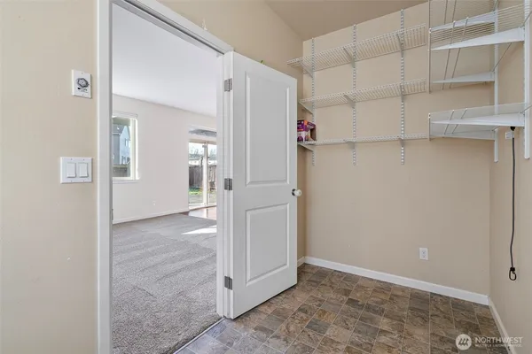 an empty room with cabinet and mirrors