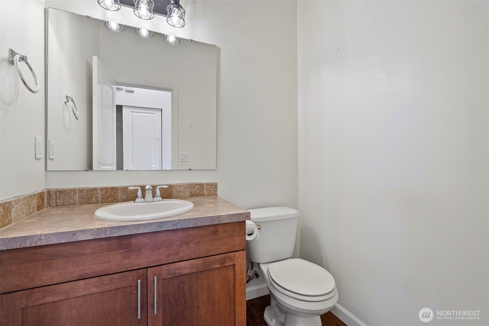 204 Balmer Street Southwest Orting, WA 98360 - Photo 14 of 29 a bathroom with a toilet a sink and mirror