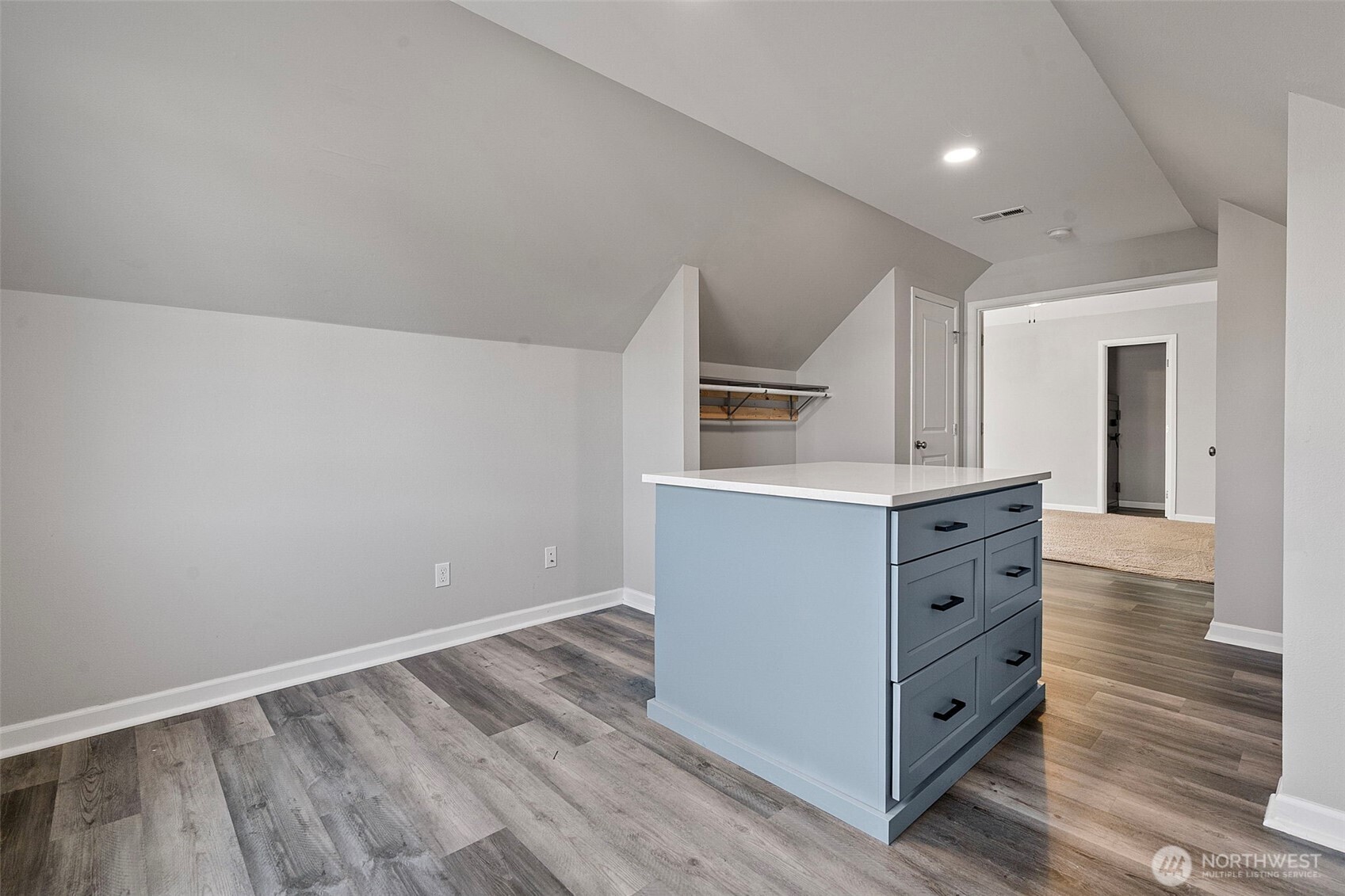 204 Balmer Street Southwest Orting, WA 98360 - Photo 16 of 29 a kitchen with cabinets wooden floor and white appliances