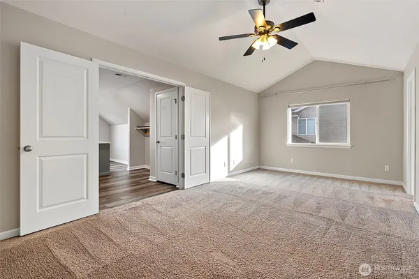 a view of a room with a ceiling fan a ceiling fan and closet