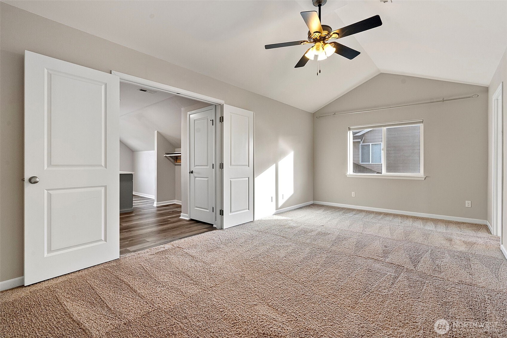 204 Balmer Street Southwest Orting, WA 98360 - Photo 17 of 29 a view of a room with a ceiling fan a ceiling fan and closet