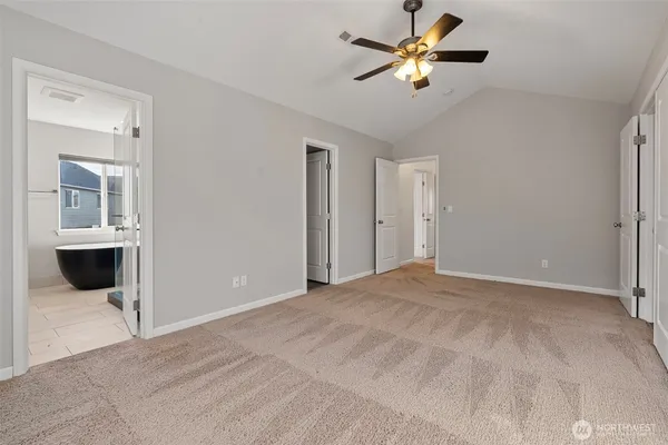 a view of a big room with chandelier fan and windows