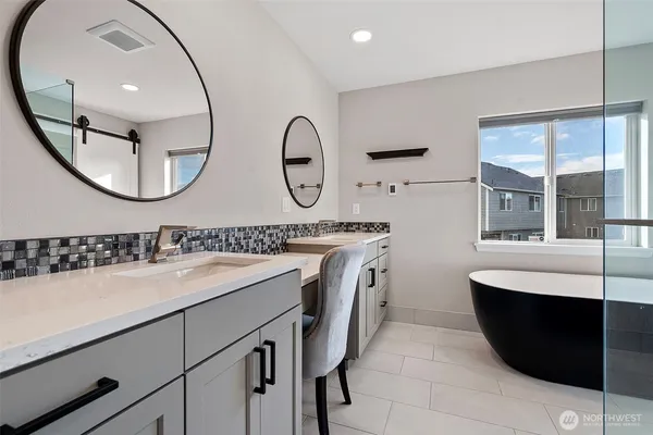 a bathroom with a double vanity sink and a mirror