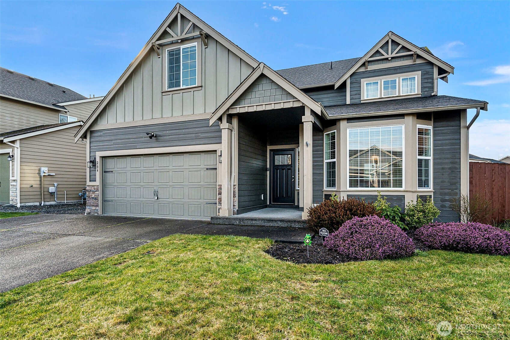 204 Balmer Street Southwest Orting, WA 98360 - Photo 2 of 29 a front view of a house with a yard
