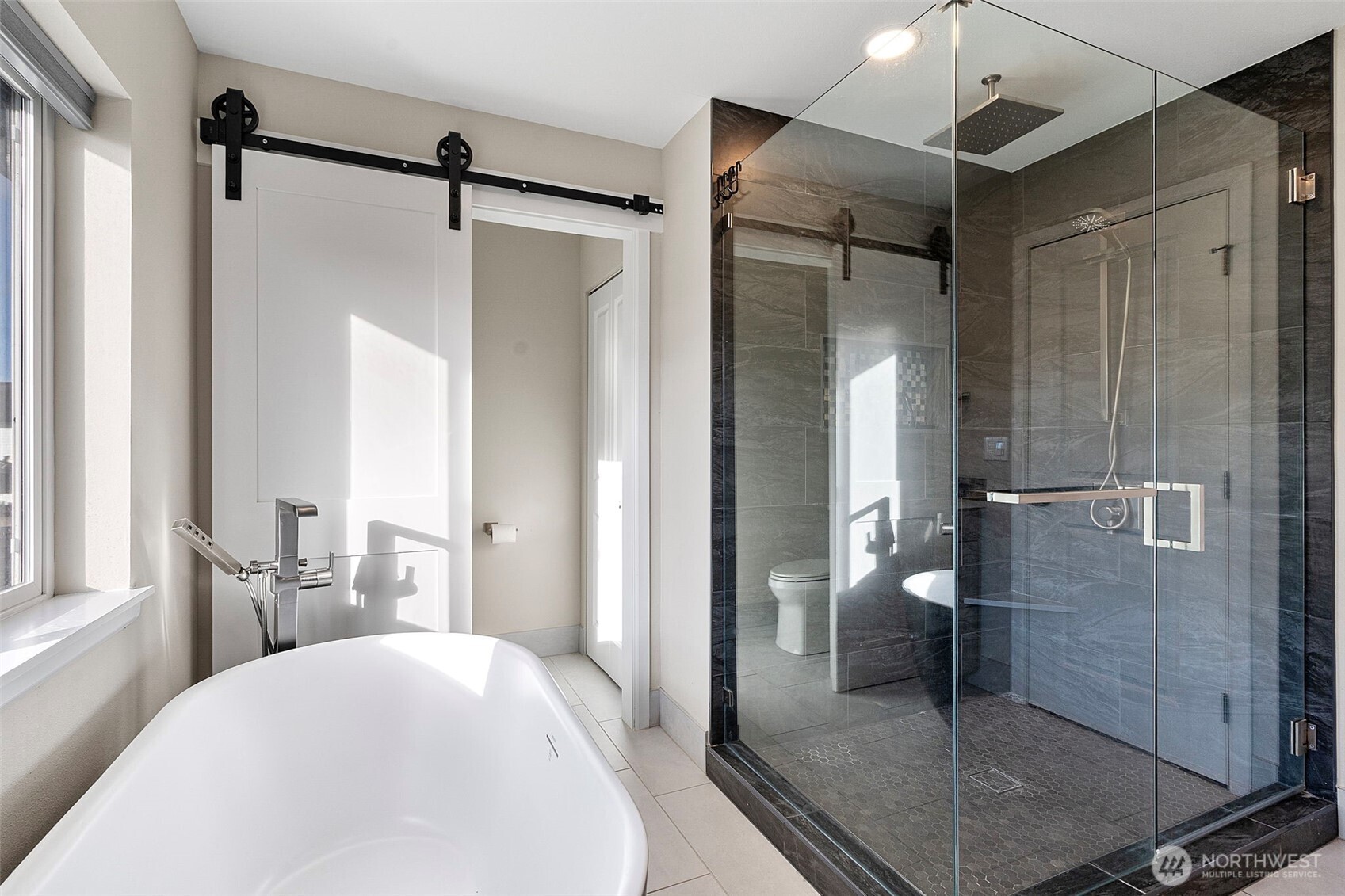 204 Balmer Street Southwest Orting, WA 98360 - Photo 21 of 29 a spacious bathroom with a glass shower door and a window