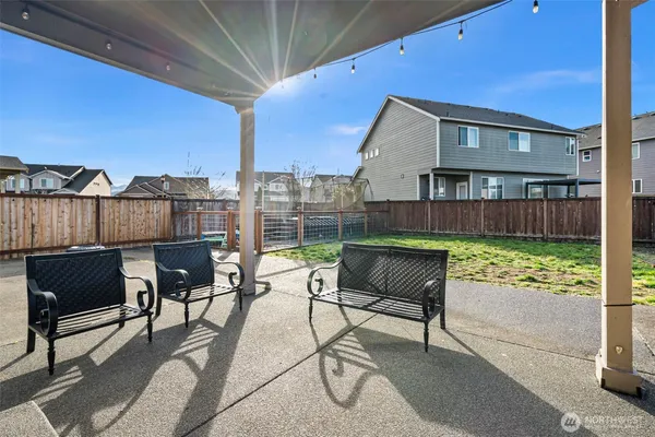 a view of a terrace with furniture and a yard