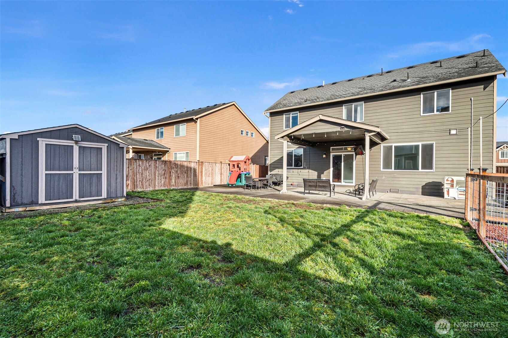204 Balmer Street Southwest Orting, WA 98360 - Photo 29 of 29 a front view of a house with patio and garden