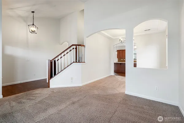a view of a hallway with entryway and stairs