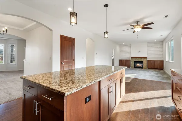 a kitchen with kitchen island a counter top space appliances and cabinets
