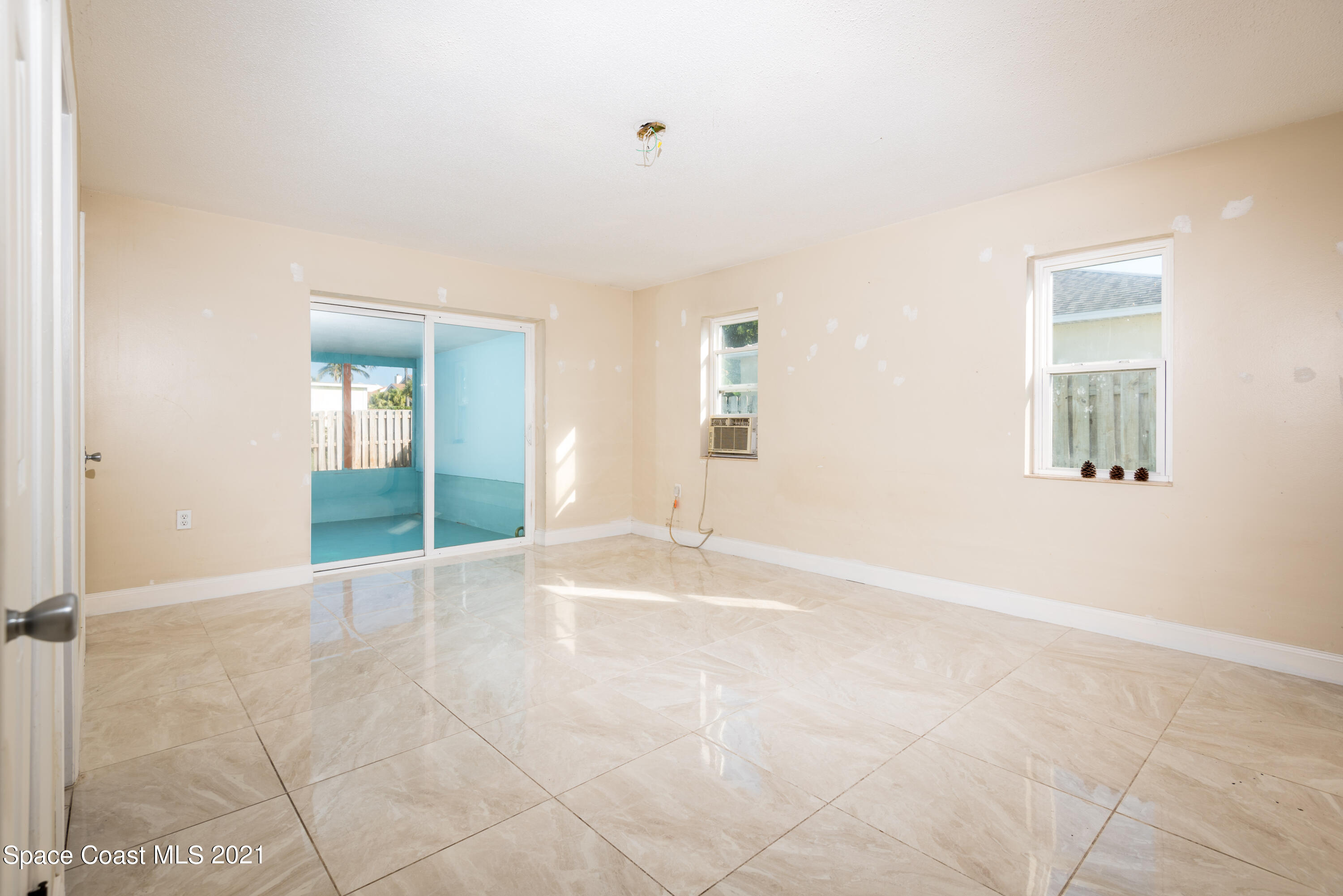 180 Richards Road Melbourne Beach, FL 32951 - Photo 14 of 49 a view of an empty room with window and chandelier fan