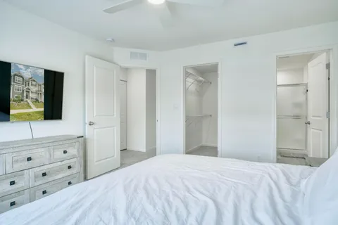 a bedroom with a bed and a flat screen tv in it
