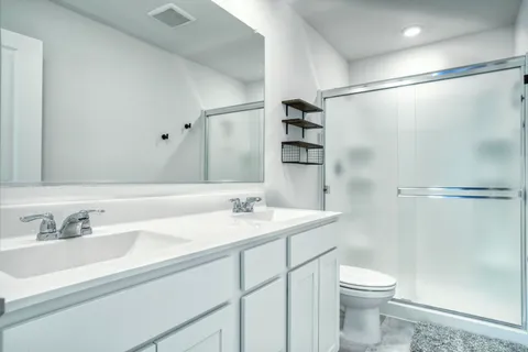 a bathroom with a sink toilet and shower