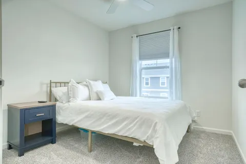 a bedroom with a bed and a window