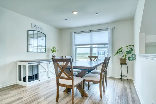 a dining room with furniture and wooden floor