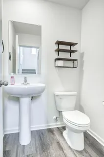 a bathroom with a sink a toilet and mirror