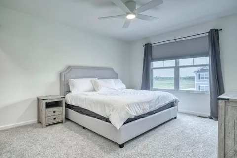 a bed sitting in a bedroom next to a window