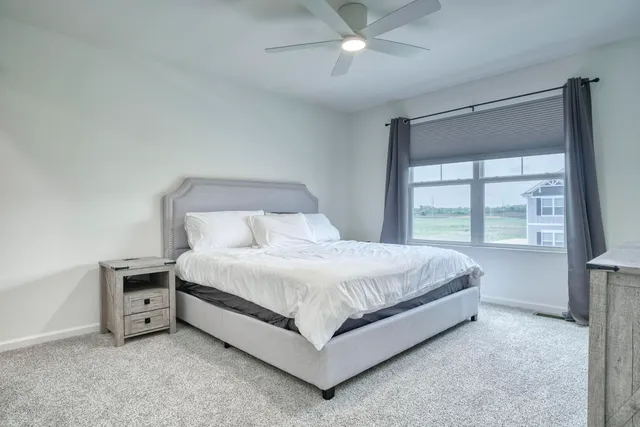 a bed sitting in a bedroom next to a window