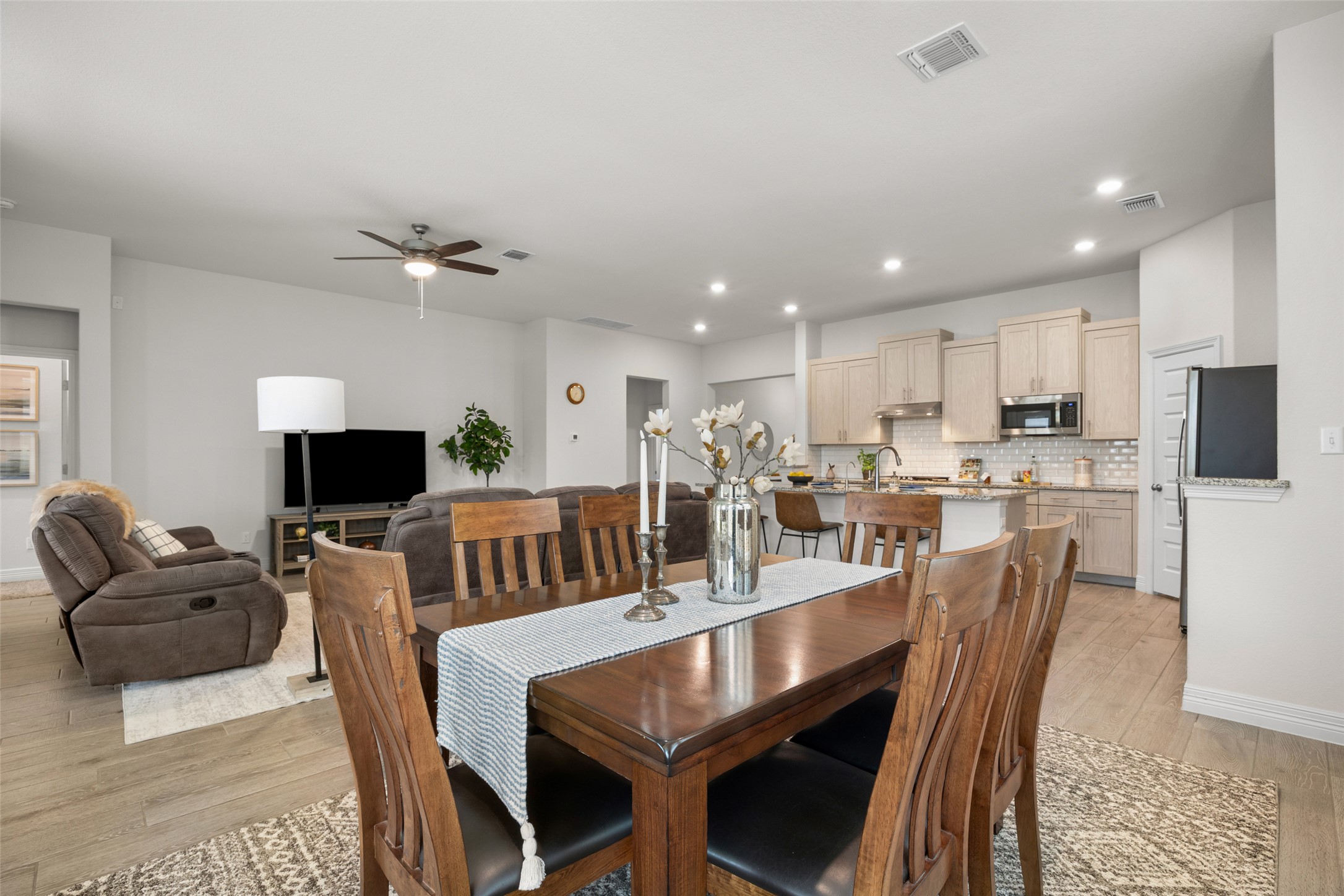 704 Muster Bend Georgetown, TX 78626 - Photo 13 of 38 Dining space featuring light wood-style floors, ceiling fan, and recessed lighting