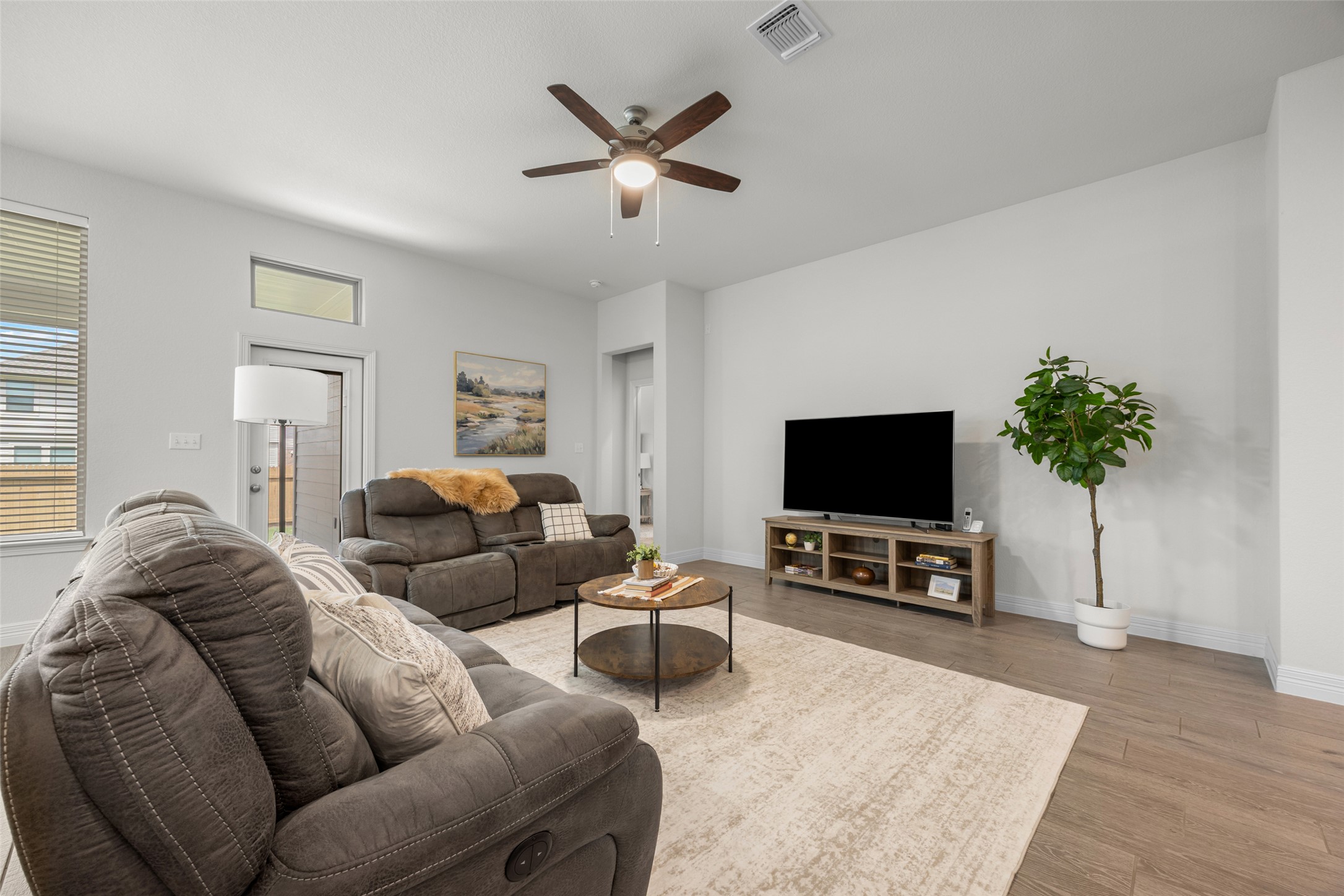 704 Muster Bend Georgetown, TX 78626 - Photo 15 of 38 Living area featuring a ceiling fan and light wood-type flooring