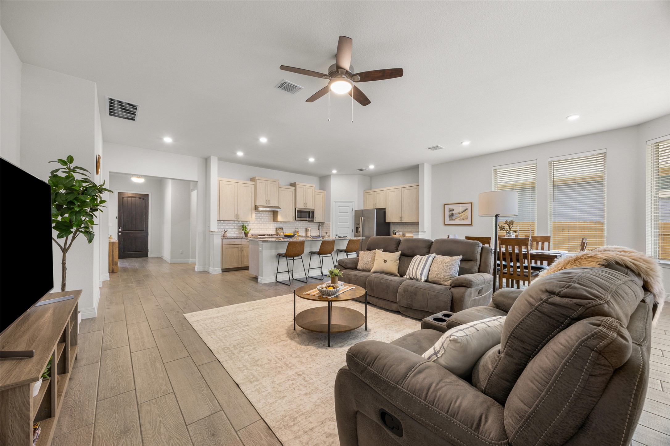 704 Muster Bend Georgetown, TX 78626 - Photo 17 of 39 Living area featuring ceiling fan, light wood-type flooring, and recessed lighting