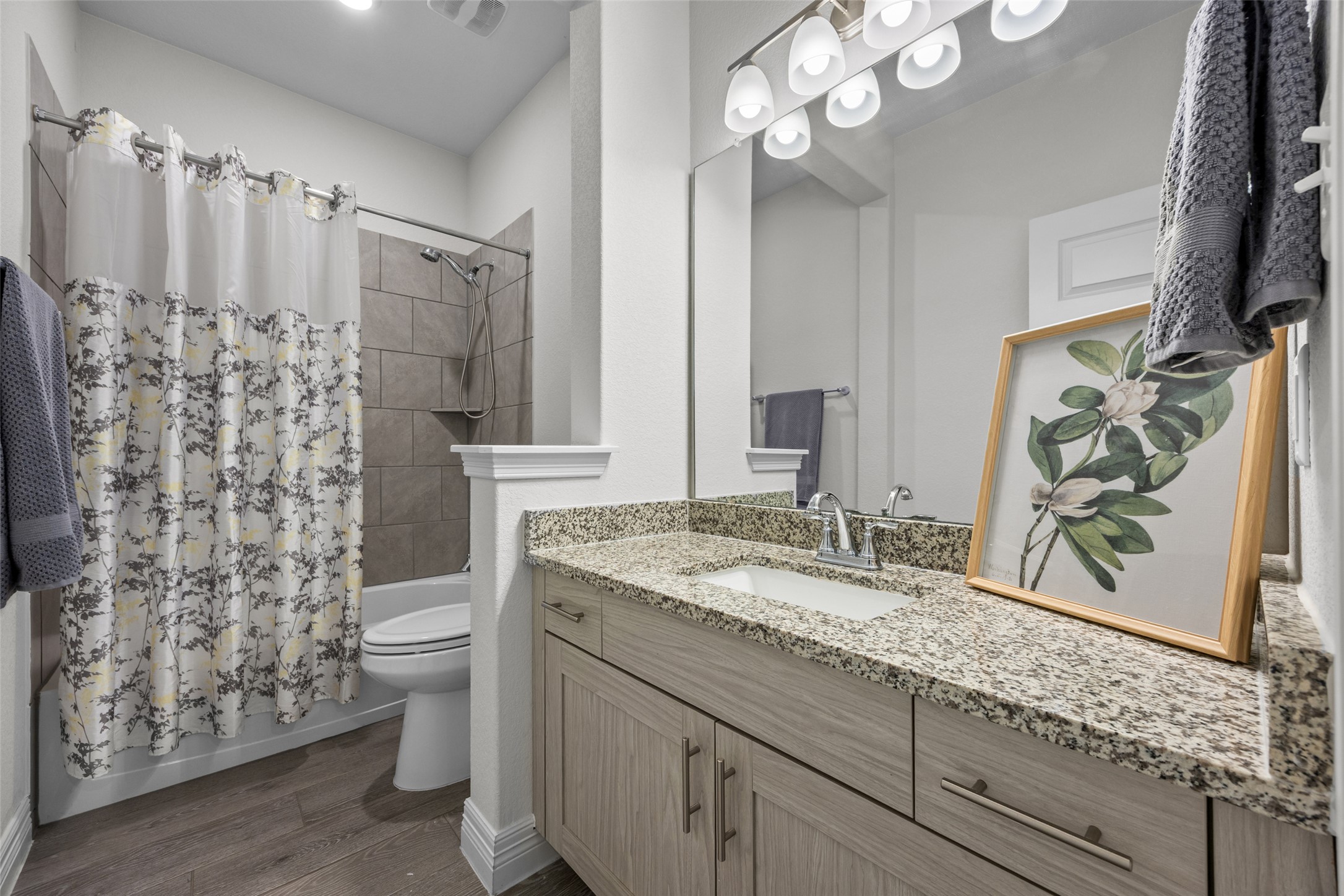 704 Muster Bend Georgetown, TX 78626 - Photo 26 of 39 Bathroom featuring vanity, shower / bath combo with shower curtain, and dark wood-type flooring