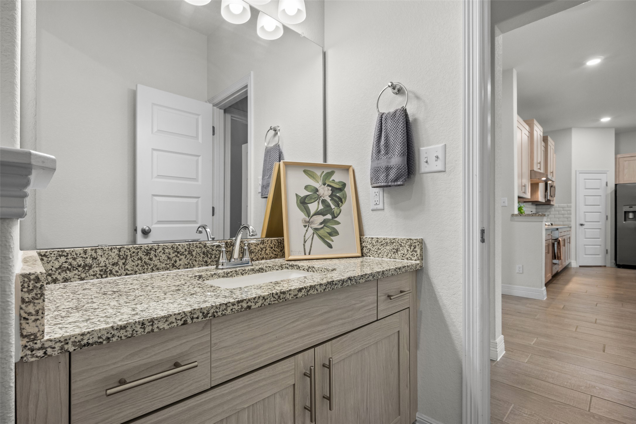 704 Muster Bend Georgetown, TX 78626 - Photo 26 of 38 Bathroom featuring vanity and light wood-style flooring