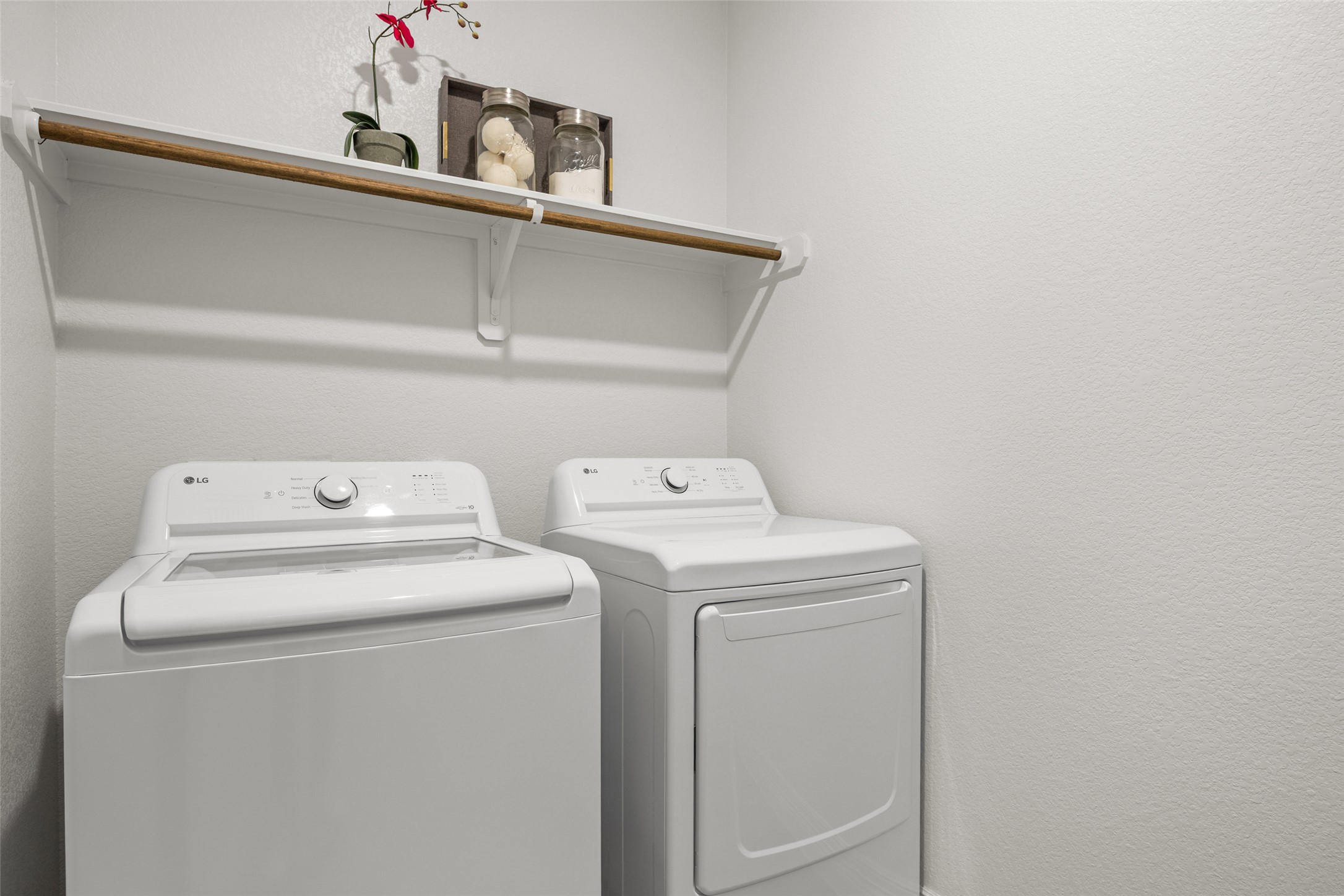 704 Muster Bend Georgetown, TX 78626 - Photo 29 of 39 Laundry area with separate washer and dryer and a textured wall