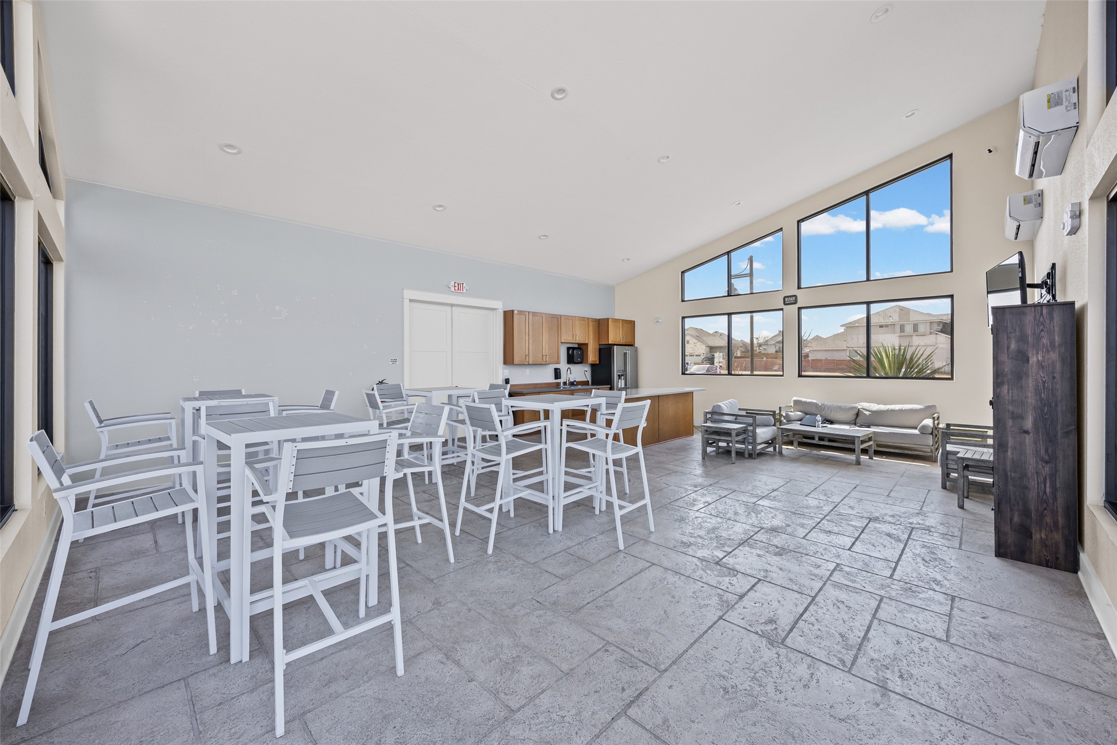 704 Muster Bend Georgetown, TX 78626 - Photo 31 of 38 Dining area with stone tile floors, a mini split for heating / cooling, and vaulted ceiling