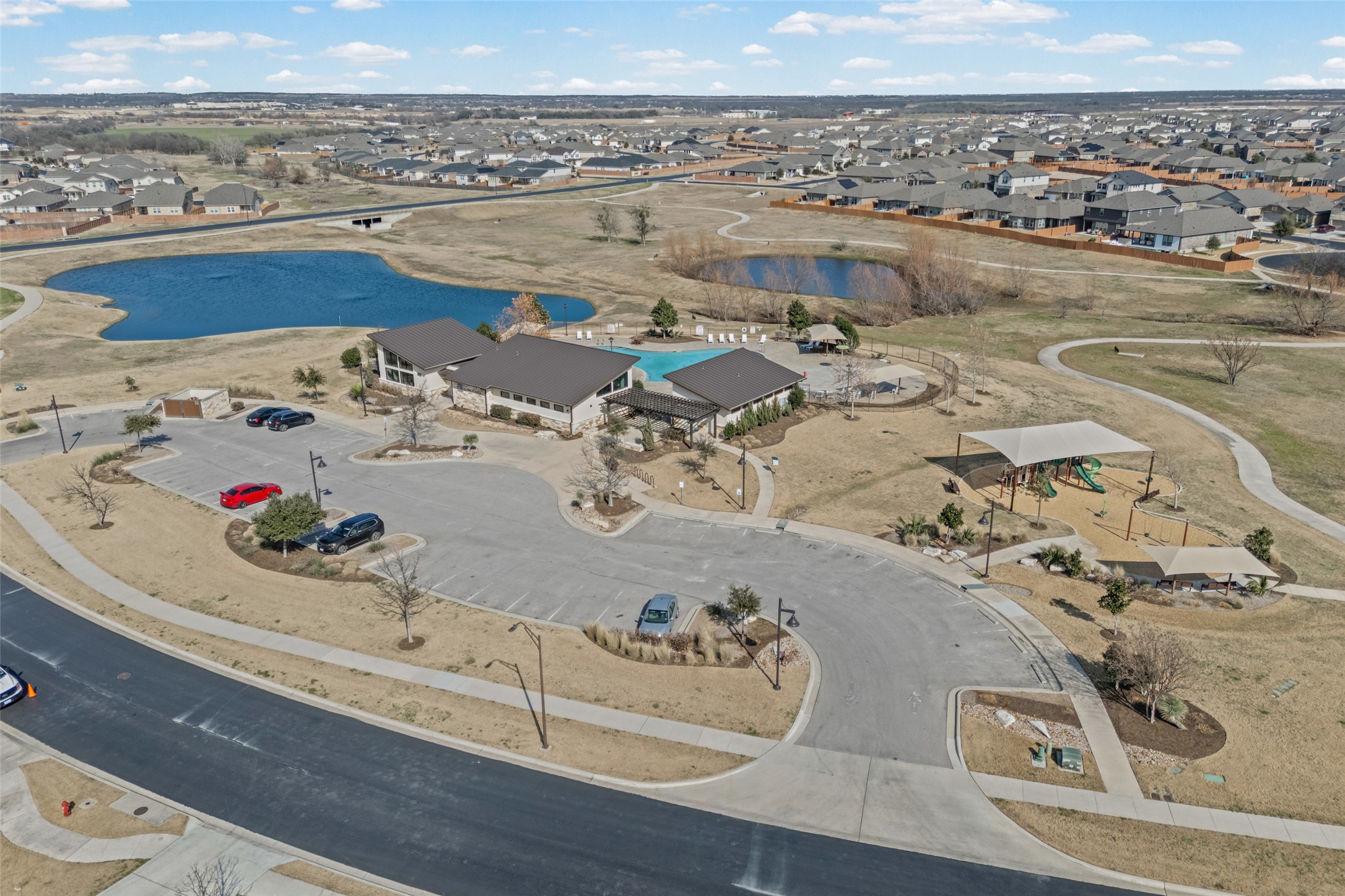 704 Muster Bend Georgetown, TX 78626 - Photo 34 of 38 Aerial view of property and surrounding area featuring a nearby body of water and nearby suburban area