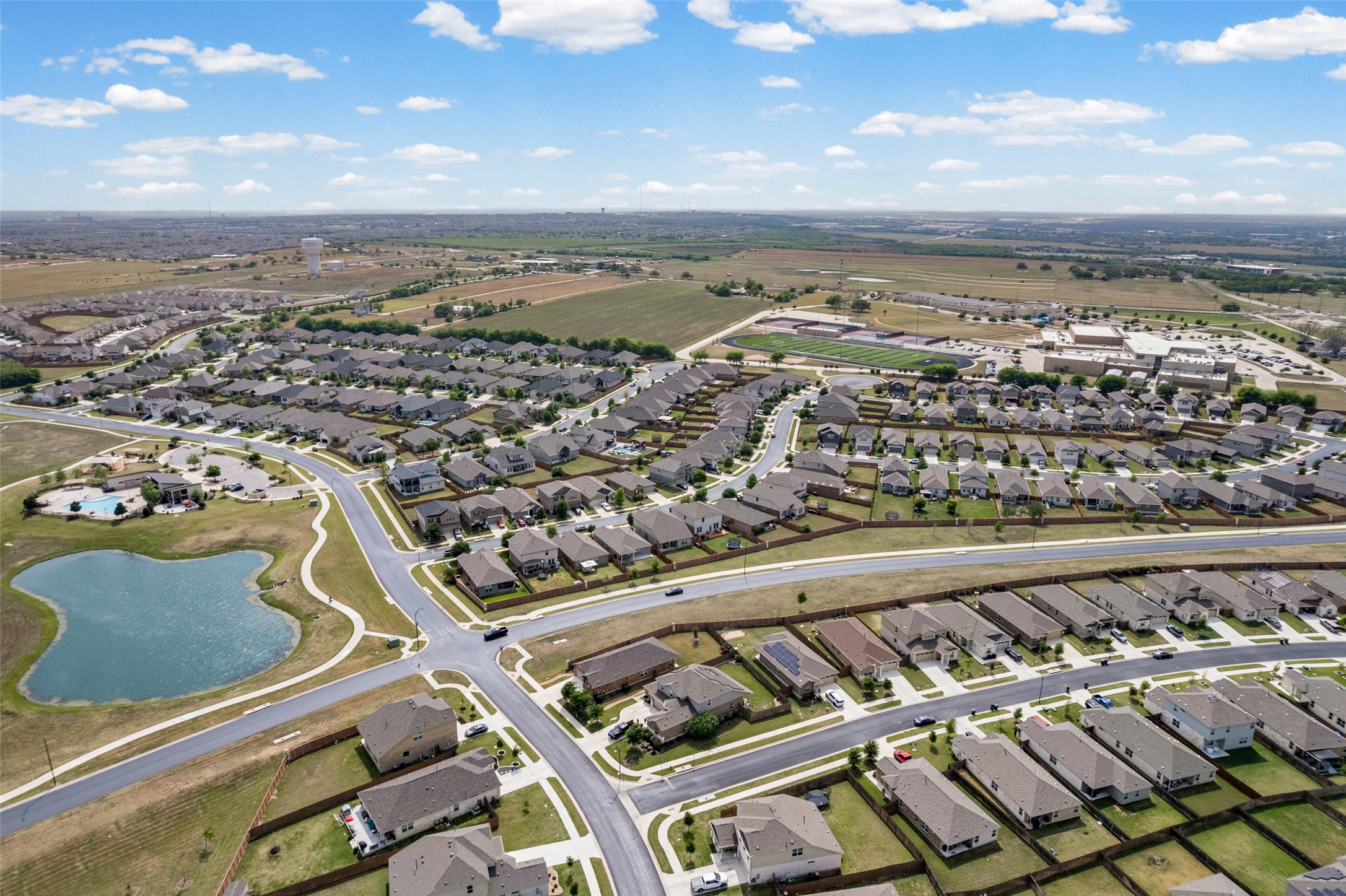 704 Muster Bend Georgetown, TX 78626 - Photo 37 of 38 Aerial perspective of suburban area featuring a nearby body of water