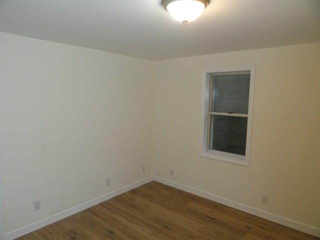 1248 East Brady Street Butler, PA 16001 - Photo 12 of 15 an empty room with wooden floor and windows