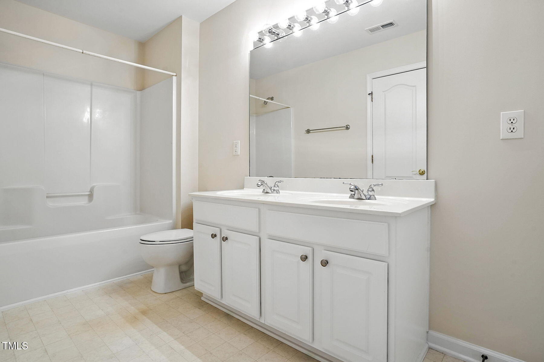 5421 Brandy Bay Road Raleigh, NC 27613 - Photo 20 of 25 a bathroom with a double vanity sink mirror and a bathtub