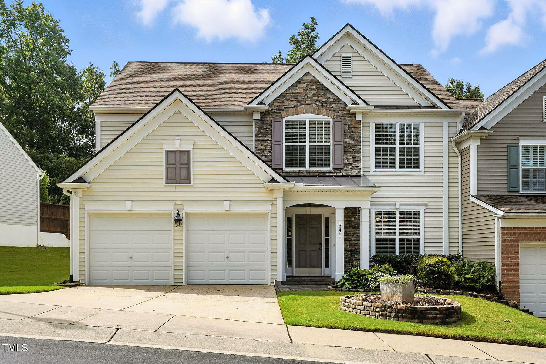 5421 Brandy Bay Road Raleigh, NC 27613 - Photo 2 of 25 a front view of a house with a yard and garage