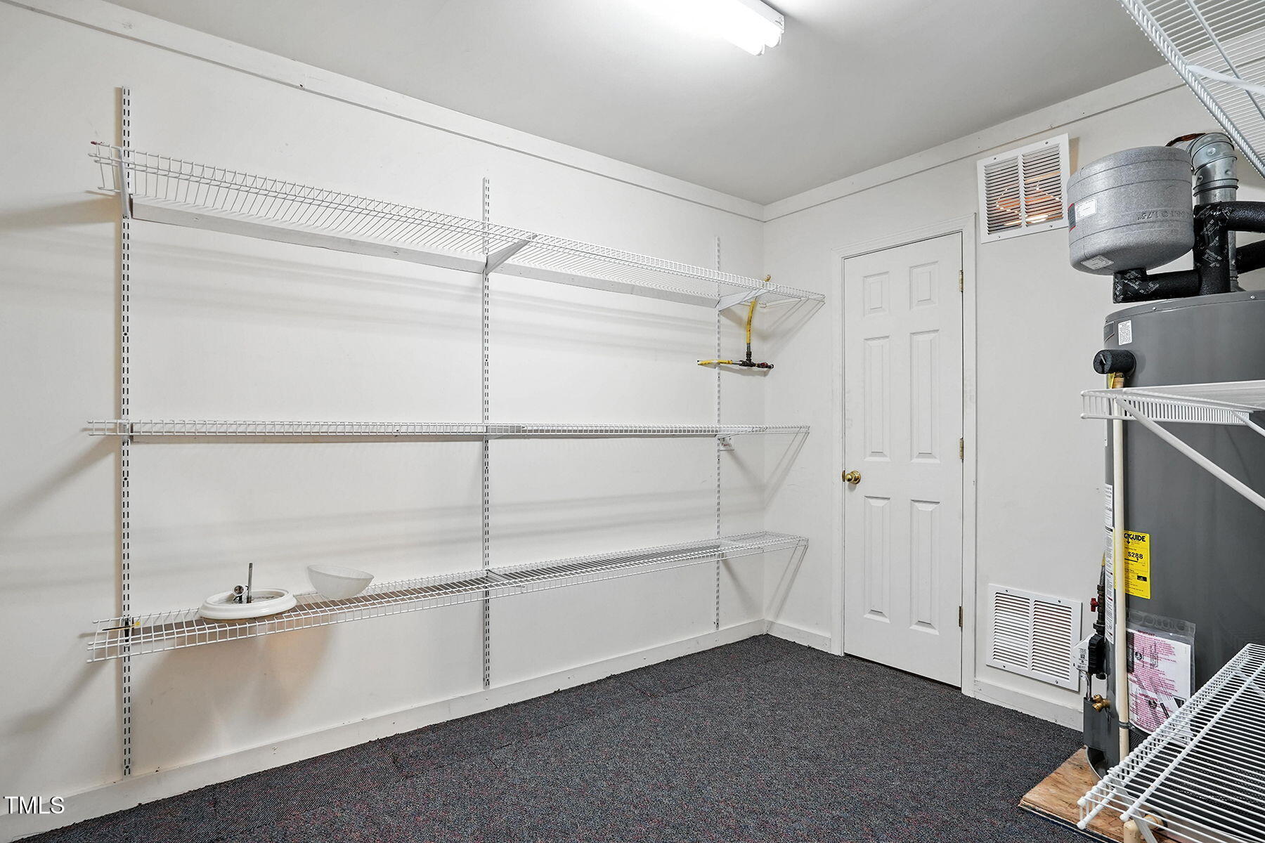 5421 Brandy Bay Road Raleigh, NC 27613 - Photo 22 of 25 a view of an empty room with empty shelves
