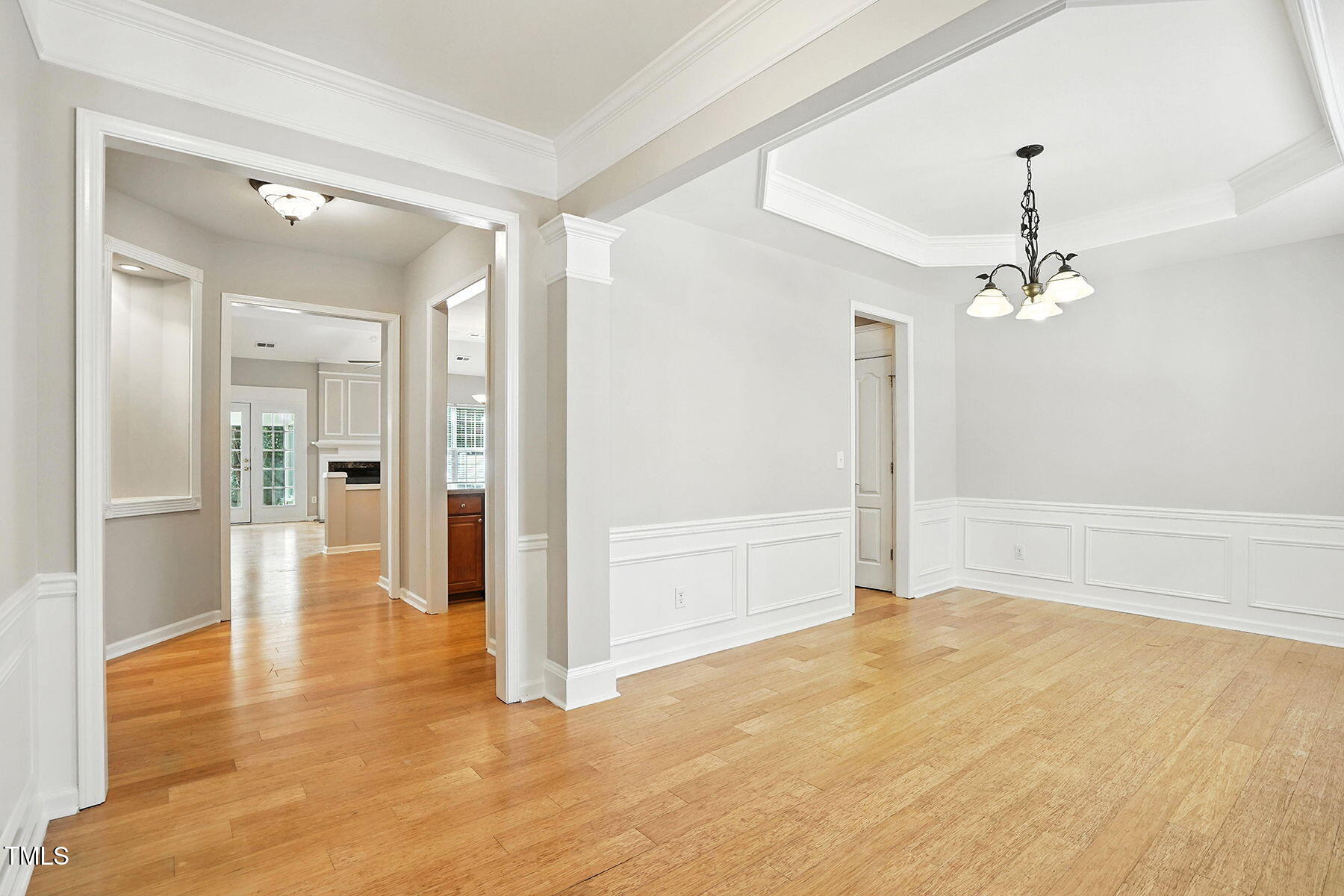5421 Brandy Bay Road Raleigh, NC 27613 - Photo 5 of 25 a view of a hallway with wooden floor and a chandelier
