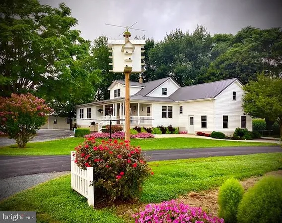a front view of a house with a yard table and chairs