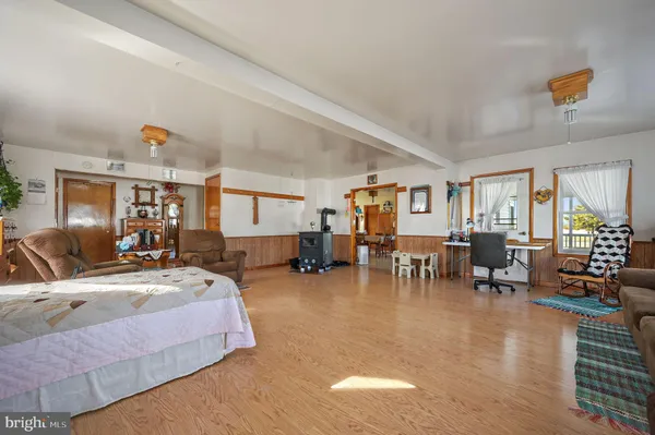 a large kitchen with kitchen island granite countertop a stove a sink a dining table and chairs