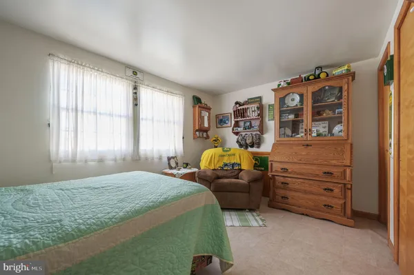 a kitchen with stainless steel appliances kitchen island granite countertop a refrigerator a sink a stove a dining table and chairs