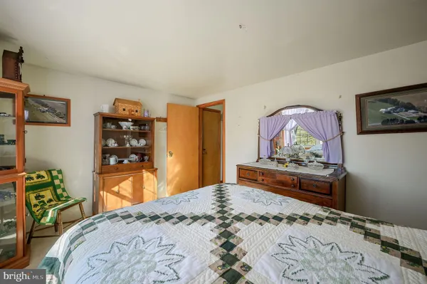 a living room with furniture a flat screen tv and a large window