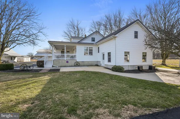 a view of a house with a yard covered with snow in the background