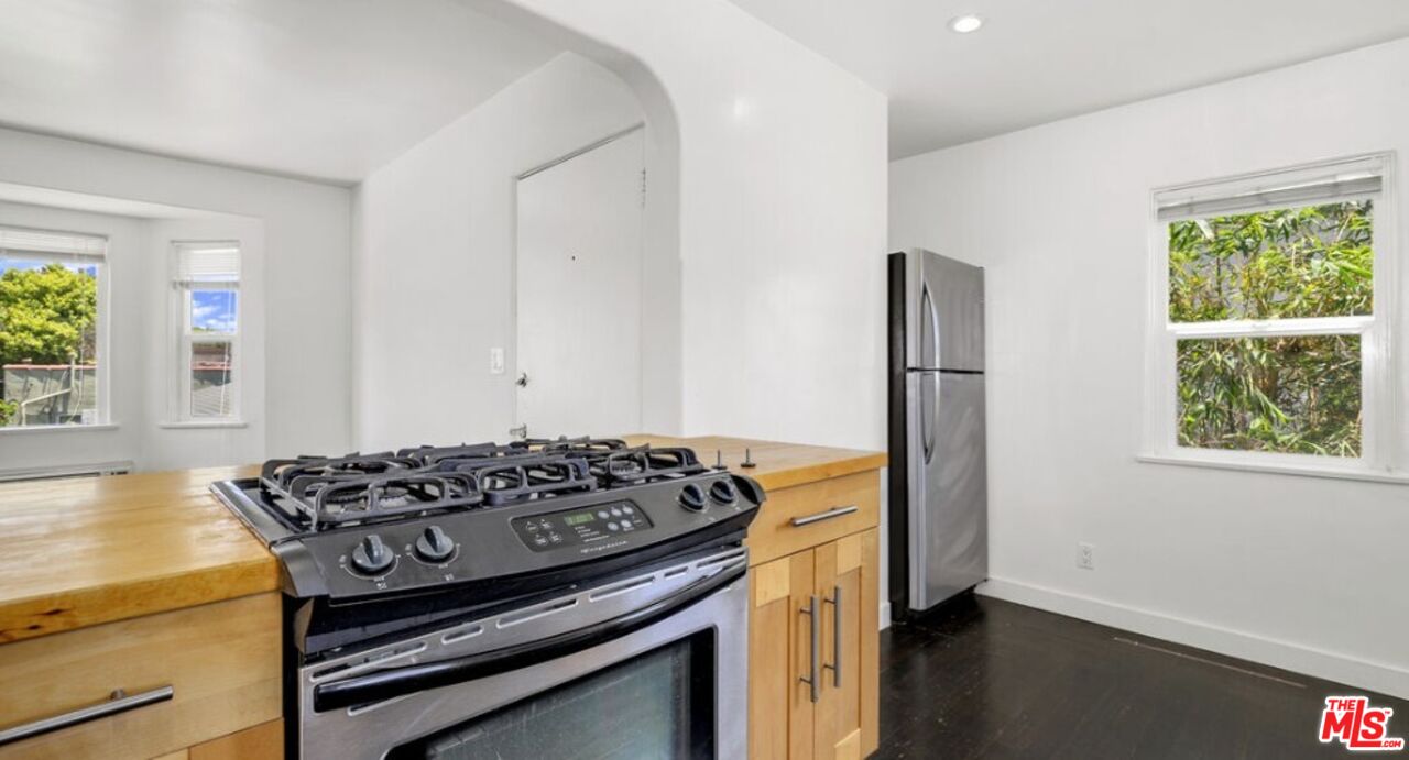 2140 20th Street, Unit A Santa Monica, CA 90405 - Photo 6 of 15 a kitchen with a stove and a window